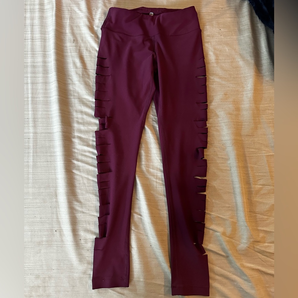 Burgundy leggings with slits down the sides of the legs.